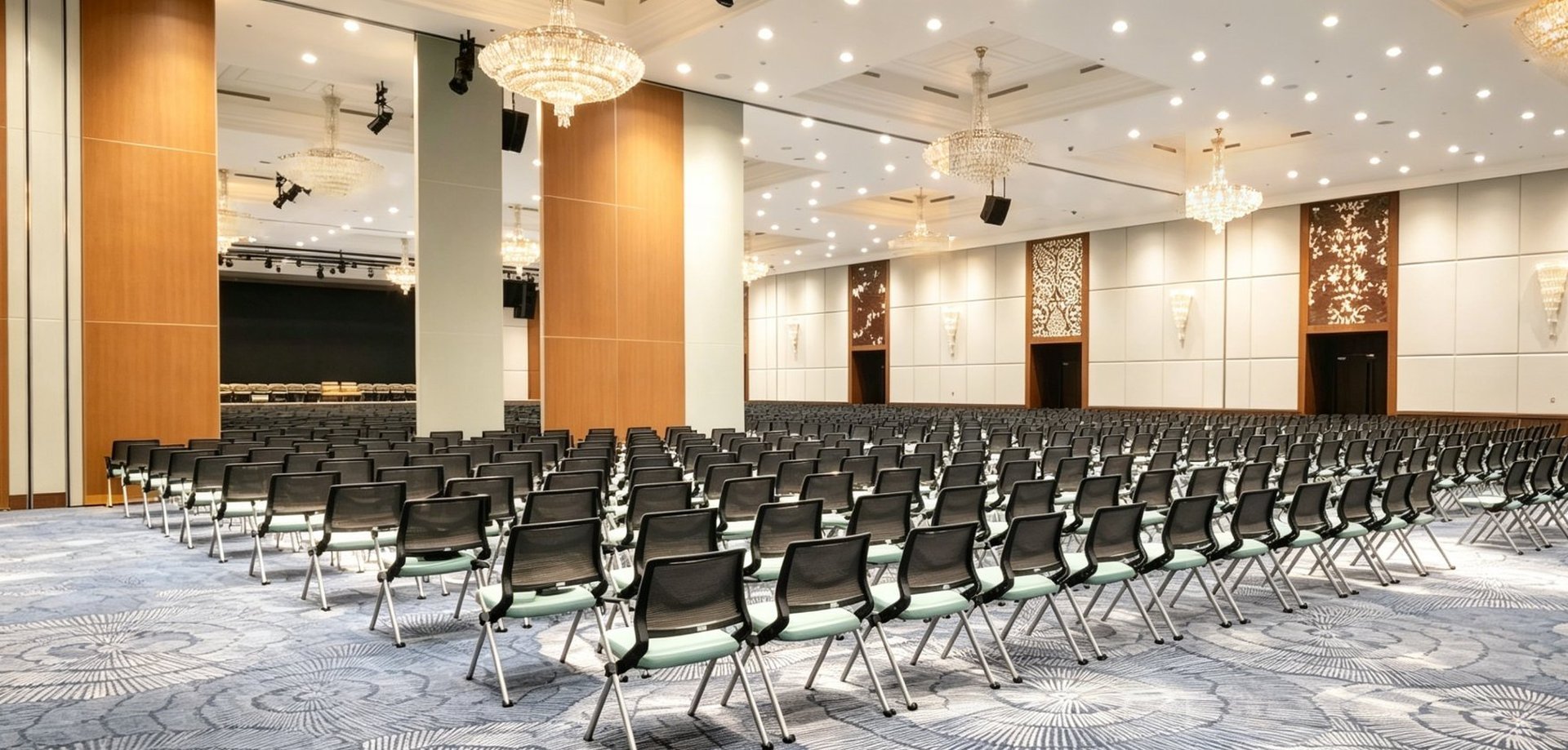 Operable partitions dividing a grand ballroom for a conference event